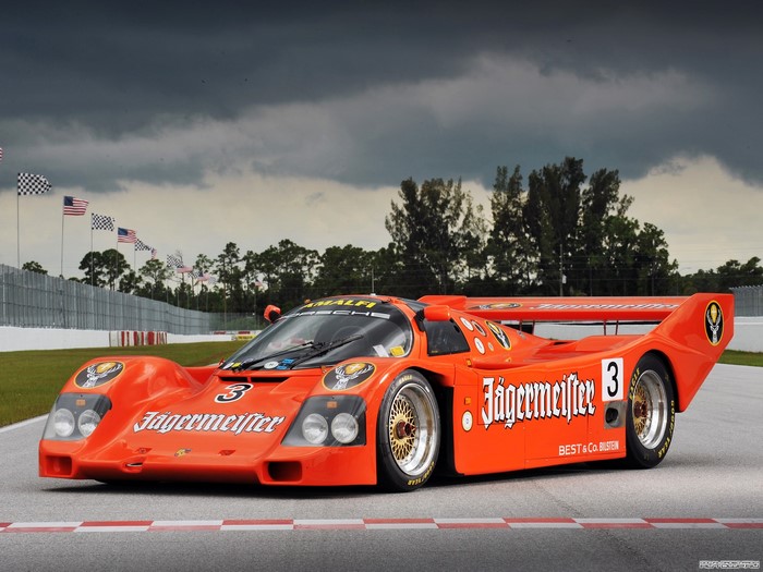 Orange Jägermeister Porsche 962C race car on track