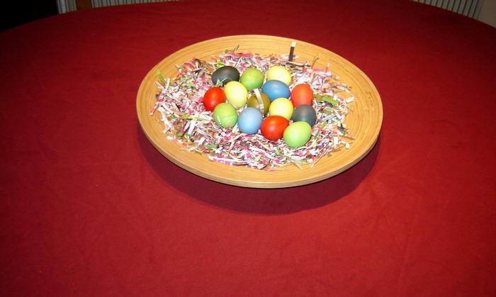 Easter eggs in a bowl on a red tablecloth