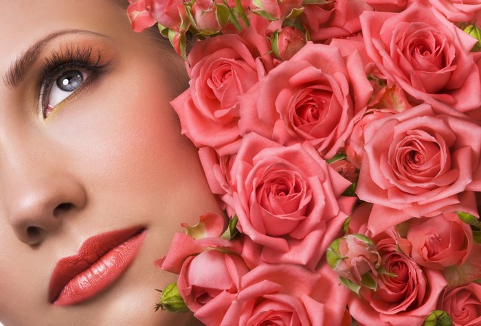Close-up of a woman's face with pink roses