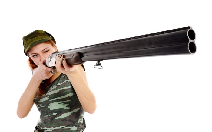 Woman aiming a shotgun