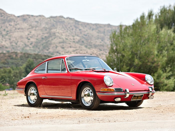 Red Porsche 911 parked on a dirt road