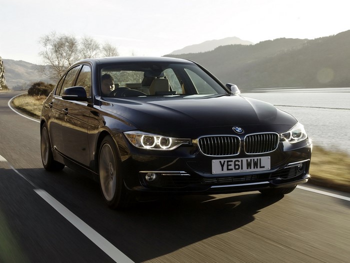 Black BMW Sedan Driving on a Winding Road