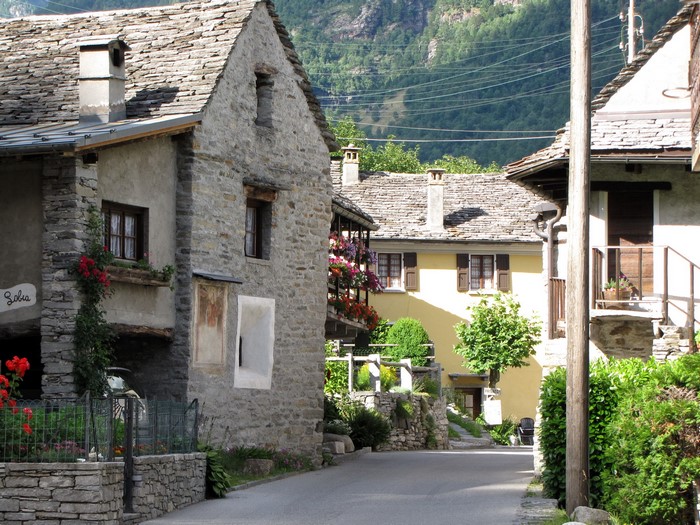 Stone houses in a Swiss village with mountains