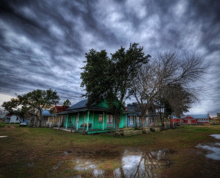 Old houses in a rural setting under a cloudy sky