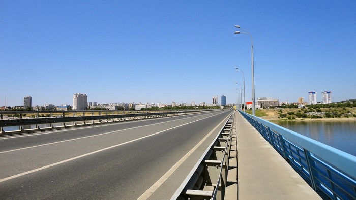 Bridge over river in Volgograd with city skyline