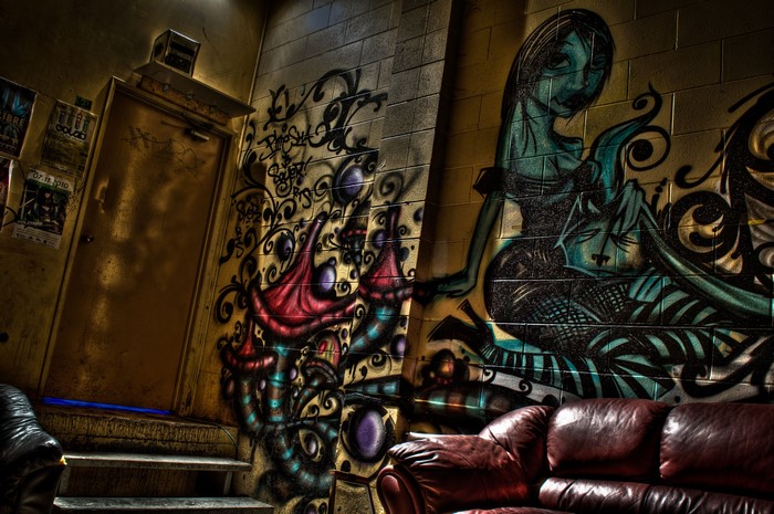 Graffiti-covered interior with leather couch