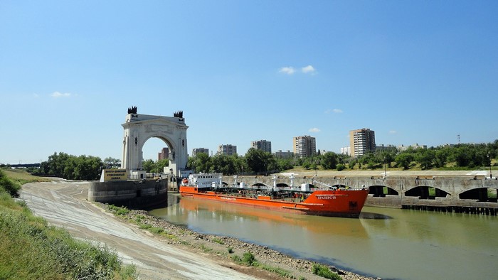 Volgograd, Russia: Ship passes through a canal lock with a large archway