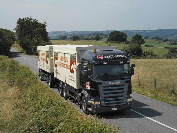 Scania truck with Paardenvoeders trailer on a road