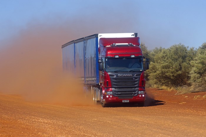 Scania truck driving on a dirt road