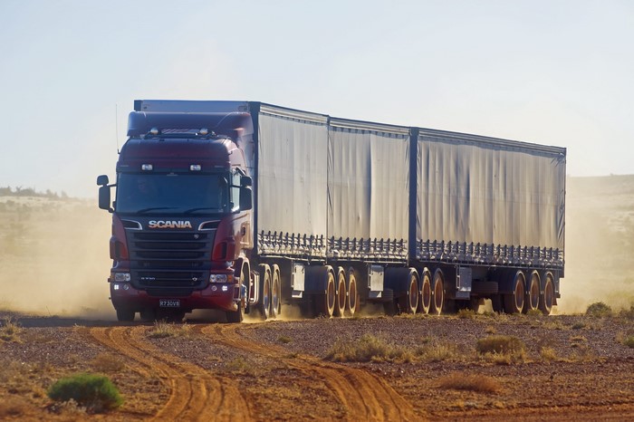 Scania truck driving on a dirt road