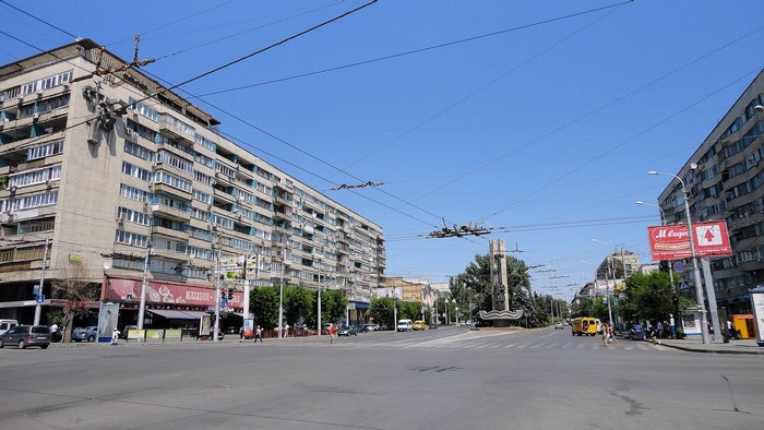 Street view in Volgograd, Russia with apartment buildings and trolleybus wires