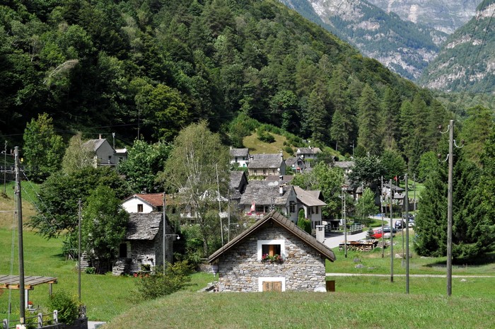 Stone houses in a mountain village with green trees