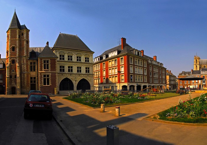 Town square with historic buildings and a park in France
