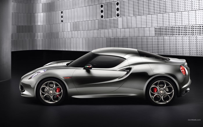 Silver Alfa Romeo 4C Spider parked in front of a metallic wall