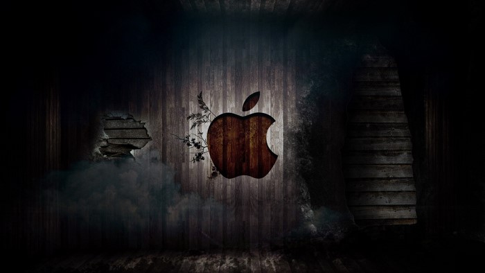 Apple logo on a wooden wall with holes