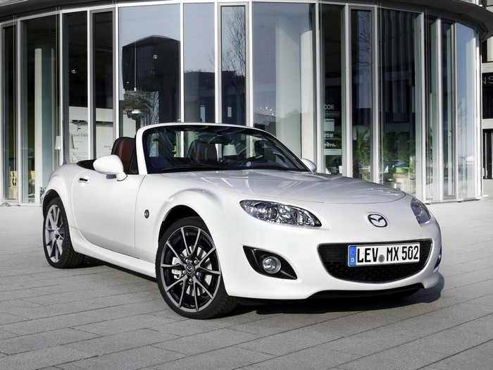 White Mazda MX-5 Convertible parked outside modern building
