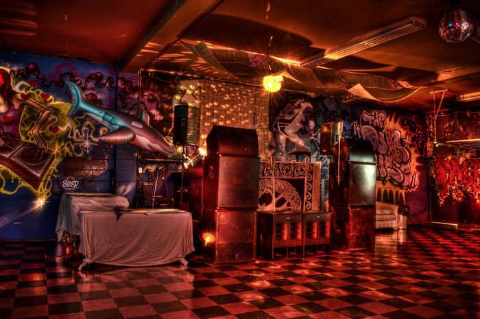 Graffiti-covered club interior with disco ball