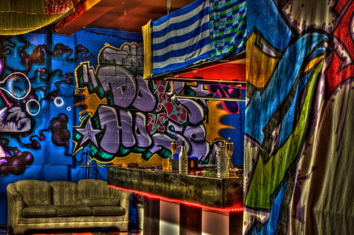 Graffiti-covered bar with a couch