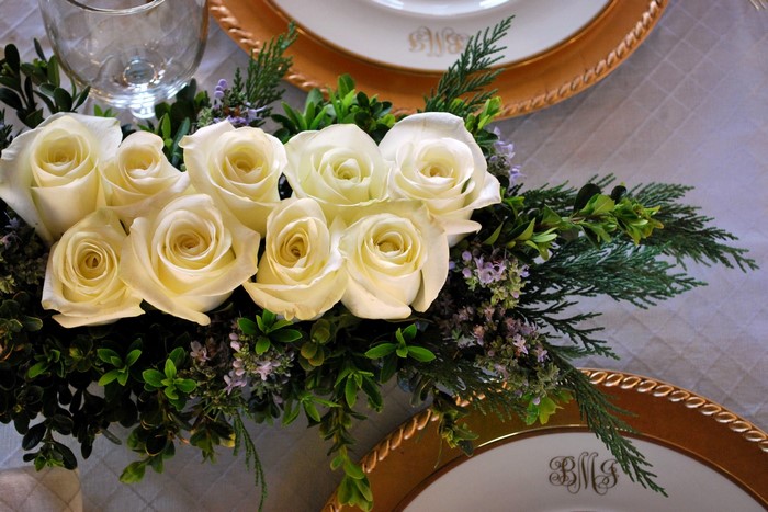 White roses centerpiece on a table setting