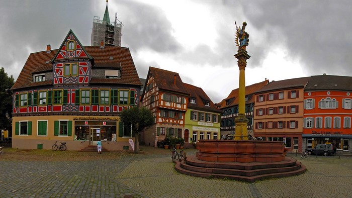 Town square with fountain and historic buildings in Germany