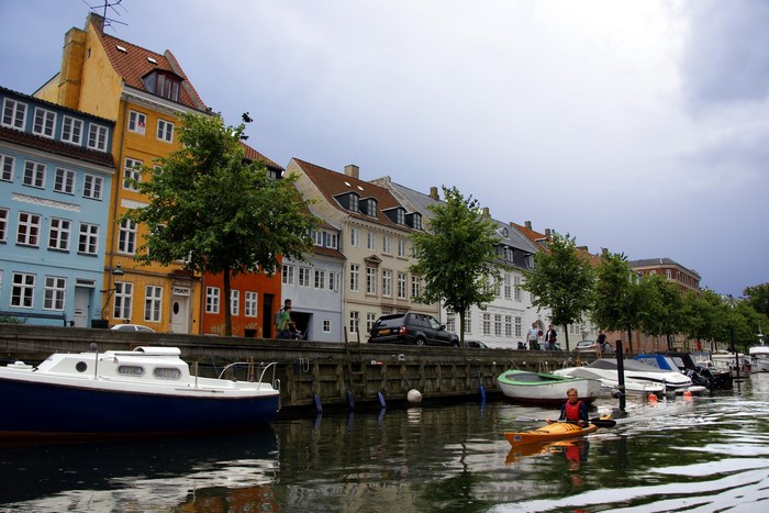 Kayaker on a canal in Nyhavn, Copenhagen, Denmark