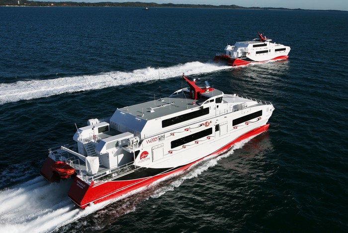Two Water Taxi Ferries Sailing on the Ocean