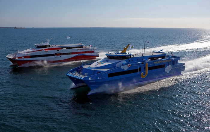 Two passenger ferries sailing on the ocean