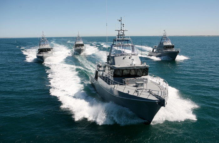 Four patrol craft sailing in formation on the ocean