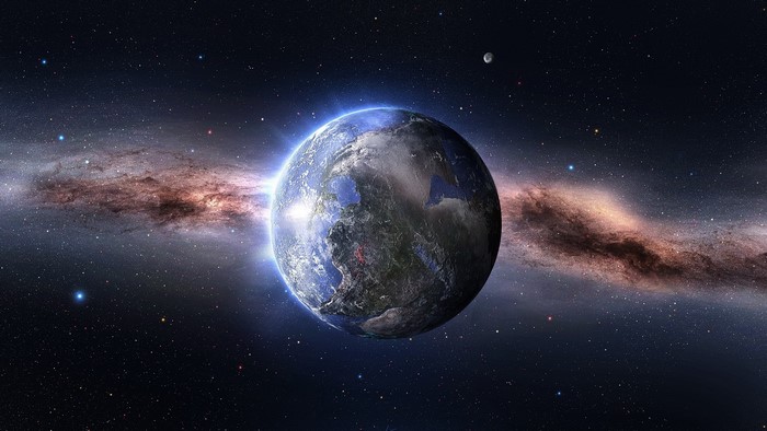 Earth and Moon in front of a galaxy