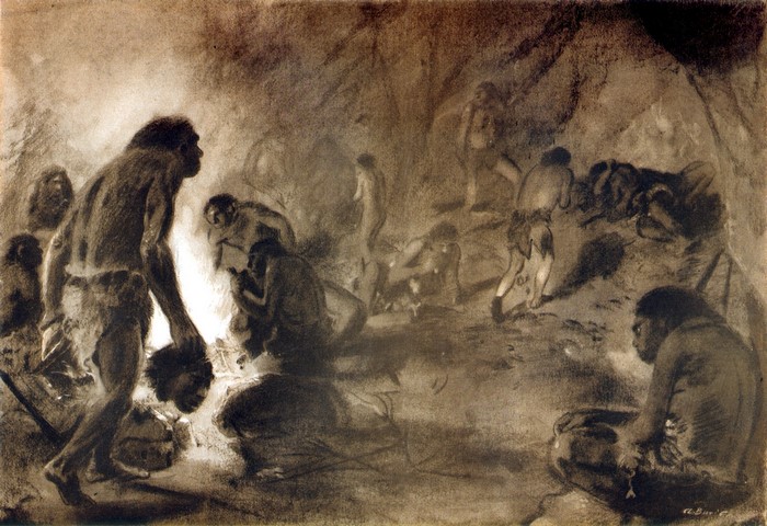 Prehistoric humans gathered around a fire in a cave