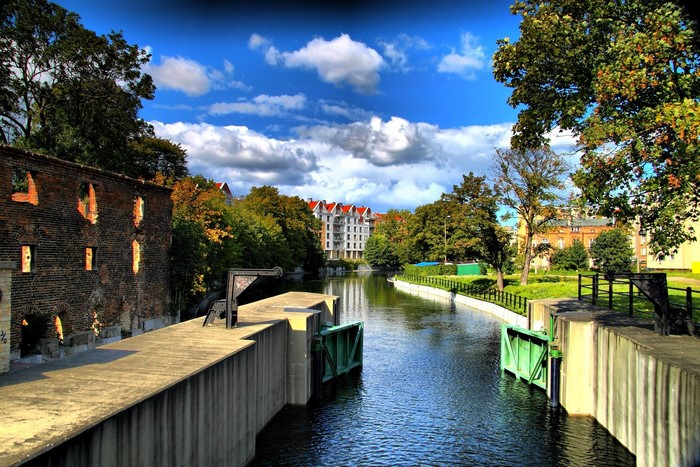Canal with old brick building and modern architecture