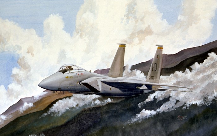F-15 Eagle fighter jet flying over mountains