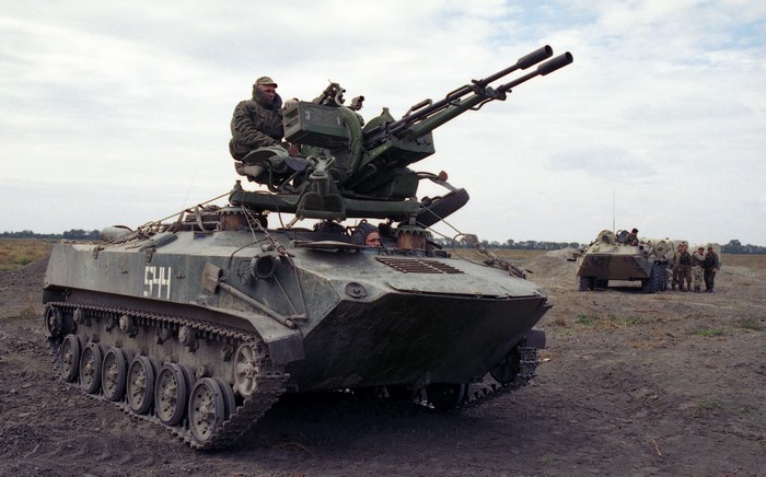 Armored personnel carrier with twin cannons and crew
