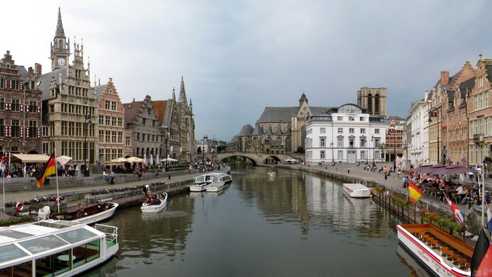 Canal with historic buildings and boats in Ghent, Belgium