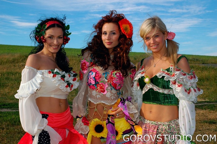 Three women in colorful outfits outdoors