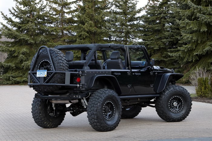 Black Jeep Wrangler with large tires and spare tire