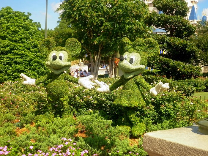 Mickey and Minnie Mouse topiaries in a park