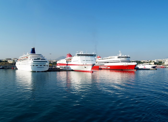 Ferries docked in a harbor under a clear blue sky