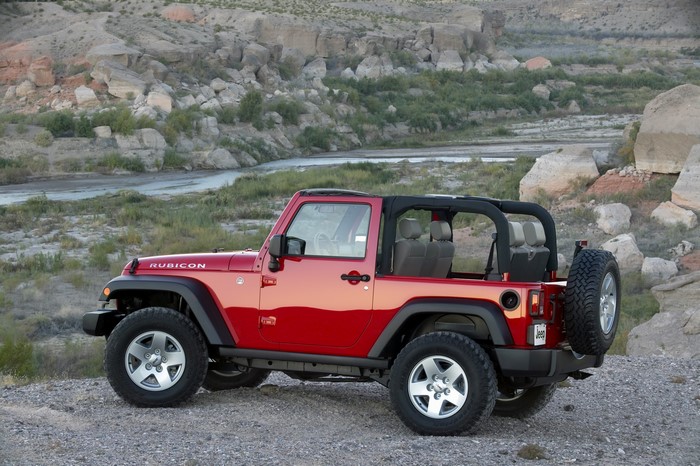 Red Jeep Wrangler Rubicon parked on rocky terrain