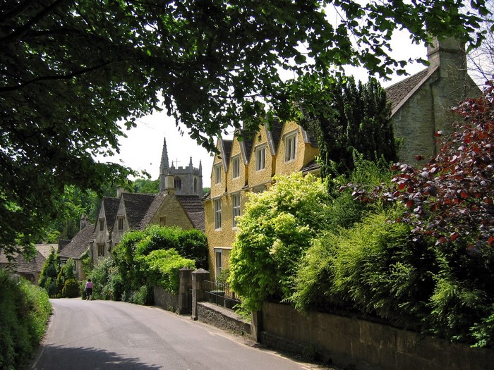 Village street with church spire in the United Kingdom