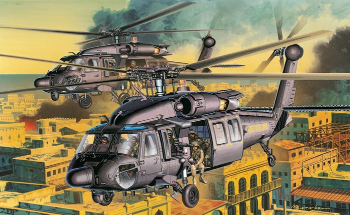 Two MH-60L Black Hawk helicopters flying over a city