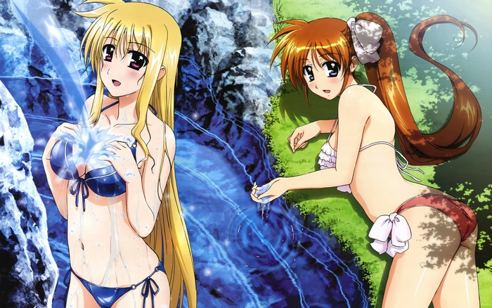 Two girls in bikinis by a waterfall