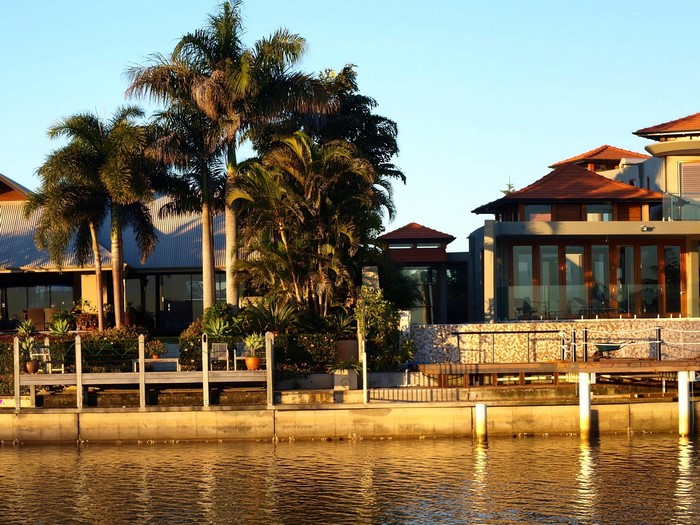 Luxury waterfront homes with palm trees