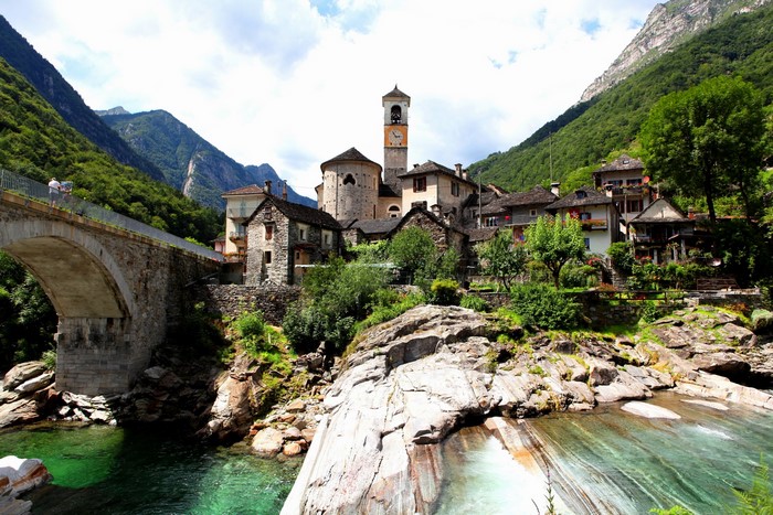 Stone bridge and village in a mountain valley, Switzerland