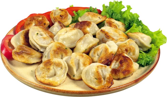Fried dumplings on a plate with lettuce and bell pepper
