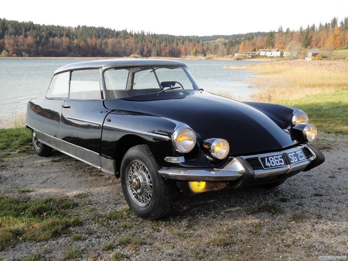 Black Citroen DS parked by a lake in autumn