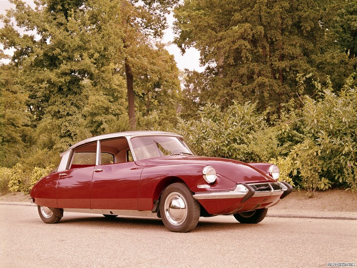 Red Citroen DS car parked on a road