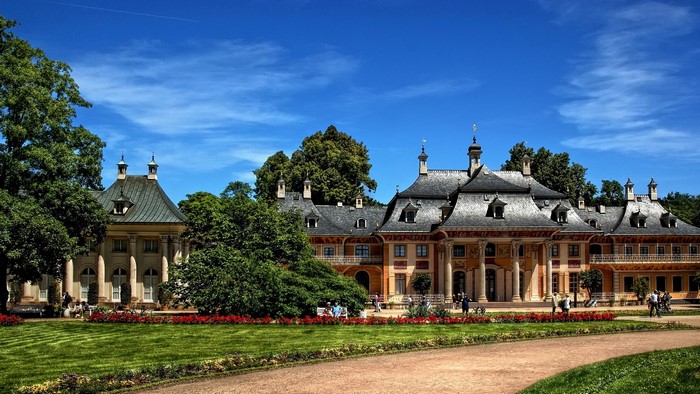 Palace with manicured gardens and trees