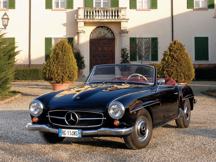 Black Mercedes-Benz 190 SL convertible in front of a villa