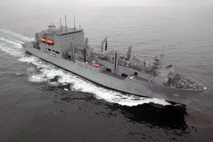 A large gray naval ship sailing on the ocean
